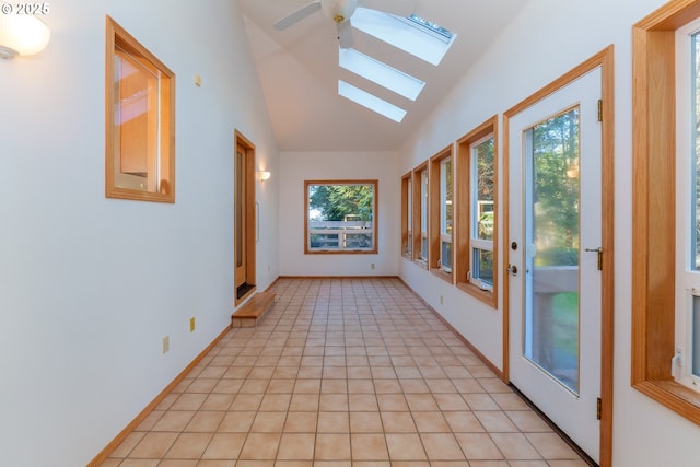 unfurnished sunroom featuring lofted ceiling with skylight and a wealth of natural light