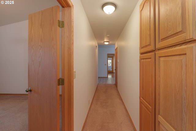 corridor featuring light colored carpet