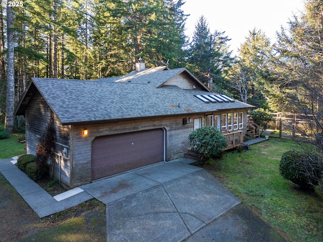 view of front facade with a garage and a front lawn