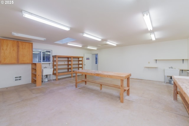 interior space featuring sink and a workshop area