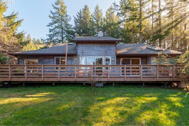 back of house featuring a wooden deck and a yard