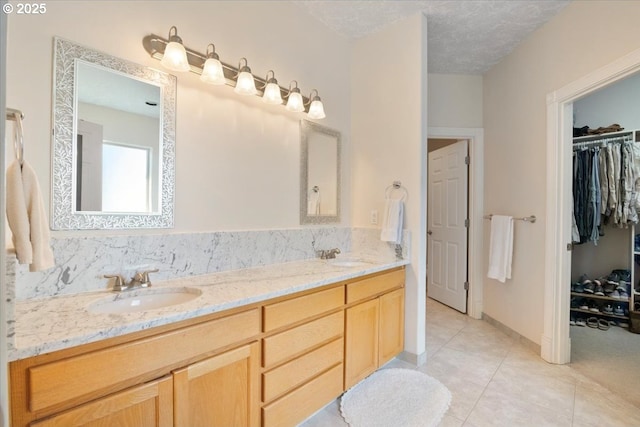 bathroom featuring vanity, tile patterned flooring, and a textured ceiling