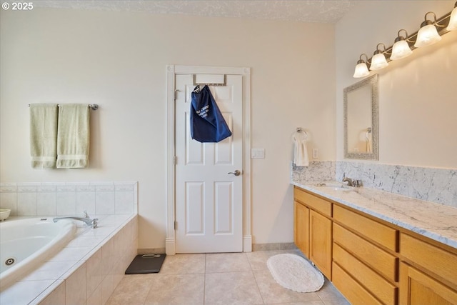 bathroom with vanity, tile patterned floors, and tiled bath