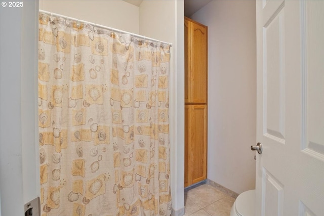 bathroom featuring tile patterned floors and toilet