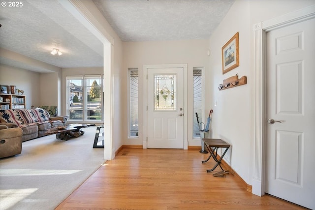 foyer featuring light hardwood / wood-style flooring and a textured ceiling