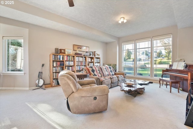 living area with light carpet and a textured ceiling