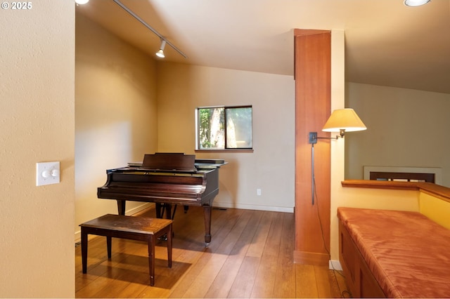 6438 SW Barnes Rd, Portland, OR 97221 - living area with rail lighting, hardwood / wood-style flooring, and baseboards