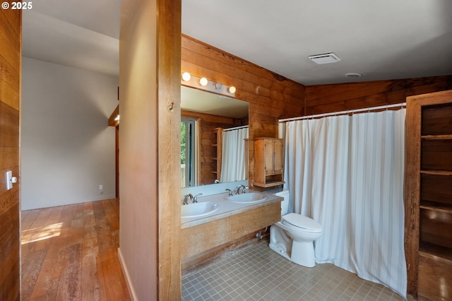 6438 SW Barnes Rd, Portland, OR 97221 - bathroom featuring toilet, double vanity, wood finished floors, and curtained shower