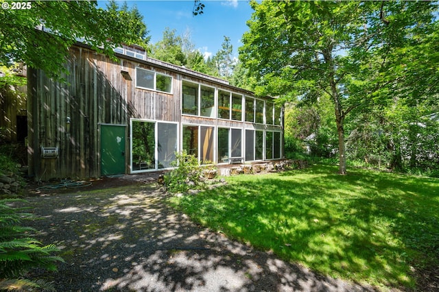 6438 SW Barnes Rd, Portland, OR 97221 - back of property featuring a yard and a sunroom