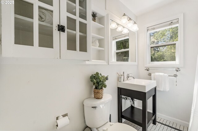 bathroom featuring vanity, tile patterned floors, and toilet