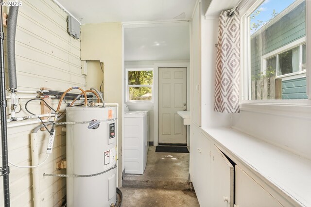 utility room featuring secured water heater and washer and clothes dryer