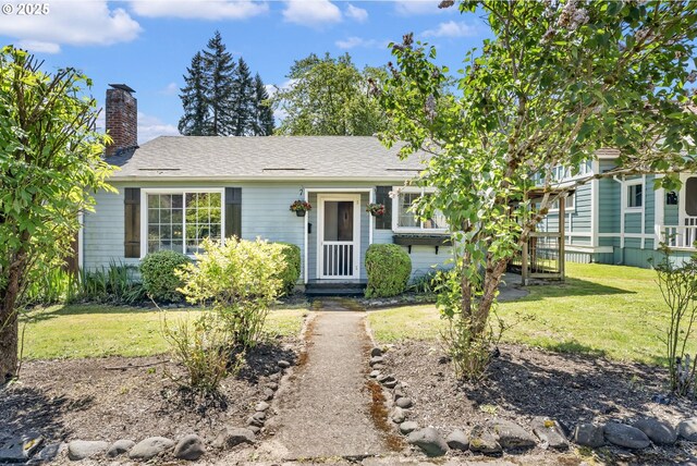ranch-style home with a front yard and a chimney