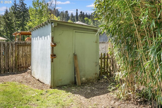 view of shed with fence