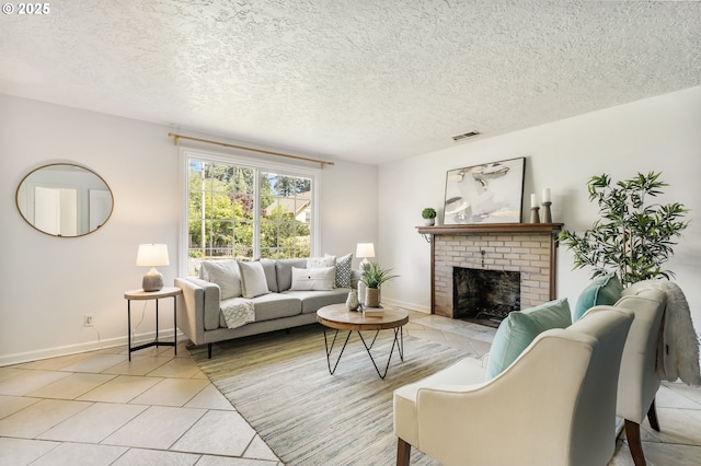 living area with visible vents, a brick fireplace, baseboards, a textured ceiling, and light tile patterned floors