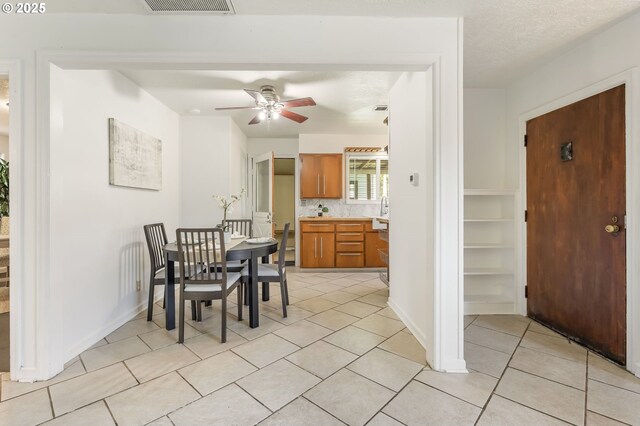 dining space with baseboards, ceiling fan, light tile patterned flooring, and visible vents