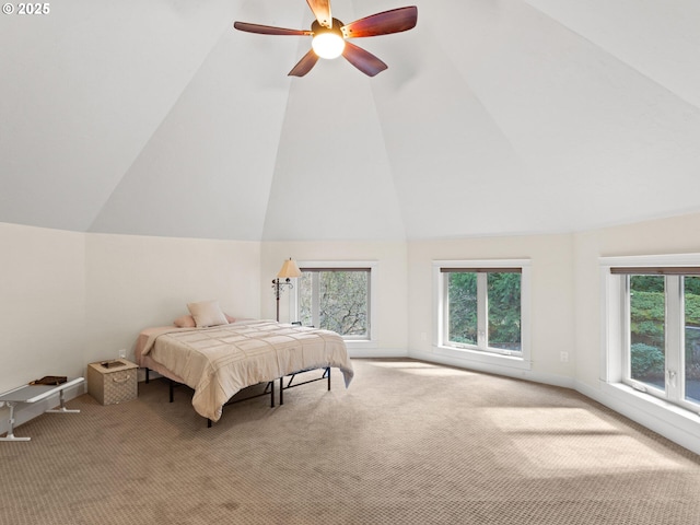 bedroom with ceiling fan, lofted ceiling, and carpet