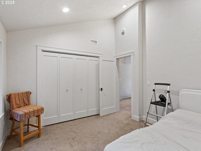 bedroom with visible vents, carpet, lofted ceiling, recessed lighting, and a closet