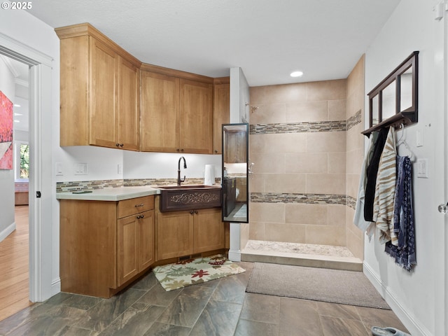 interior space with recessed lighting, a walk in shower, vanity, and baseboards