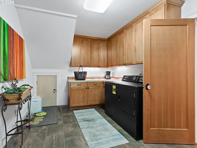 kitchen with independent washer and dryer and a textured ceiling