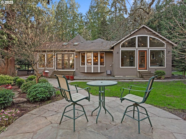 back of house featuring a patio area, entry steps, and a yard