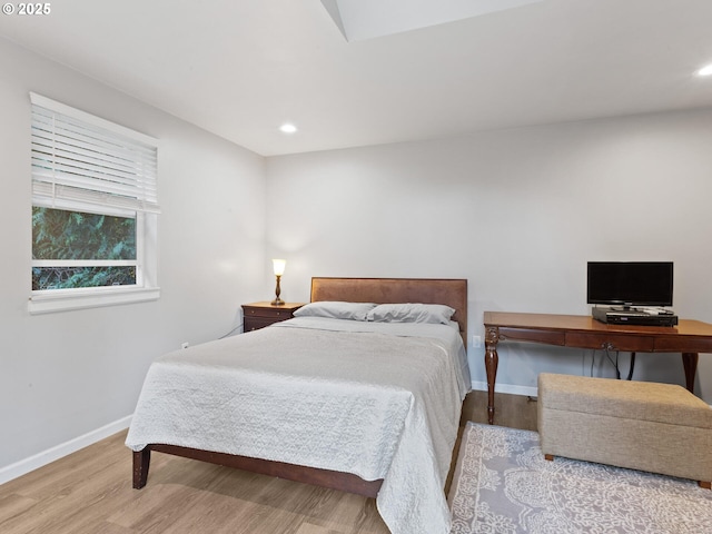 bedroom with recessed lighting, baseboards, and wood finished floors