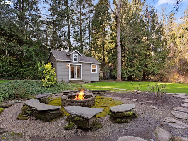 exterior space with french doors, entry steps, and an outdoor fire pit