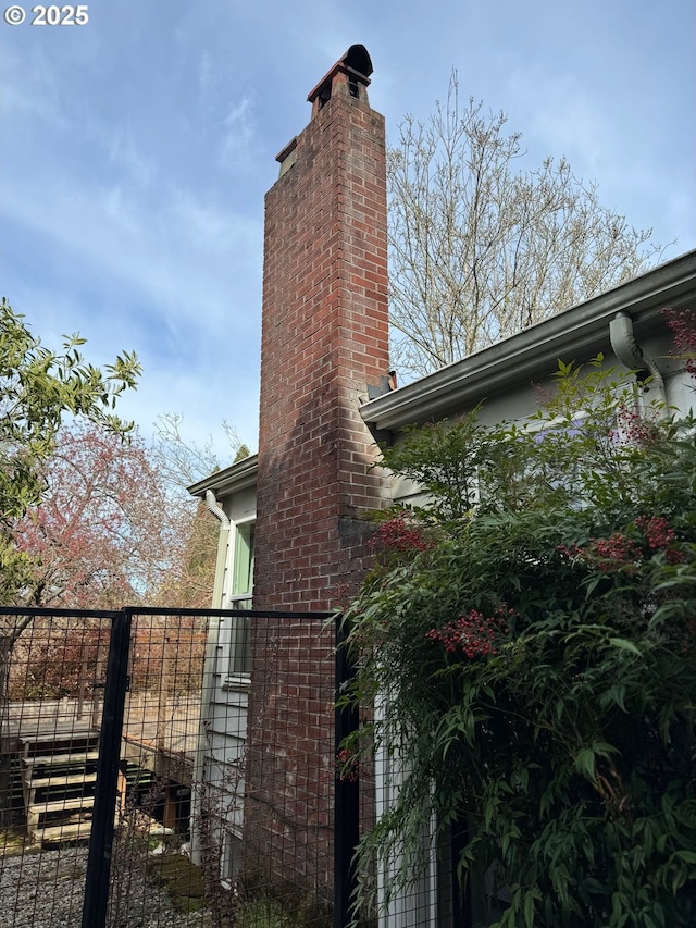 7922 SW Capitol Hill Rd, Portland, OR 97219 - view of property exterior with fence, a gate, and a chimney