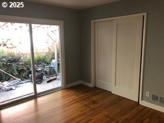 7922 SW Capitol Hill Rd, Portland, OR 97219 - unfurnished bedroom featuring wood finished floors, baseboards, and a closet