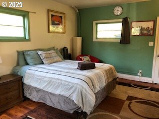 7922 SW Capitol Hill Rd, Portland, OR 97219 - bedroom with multiple windows and wood finished floors