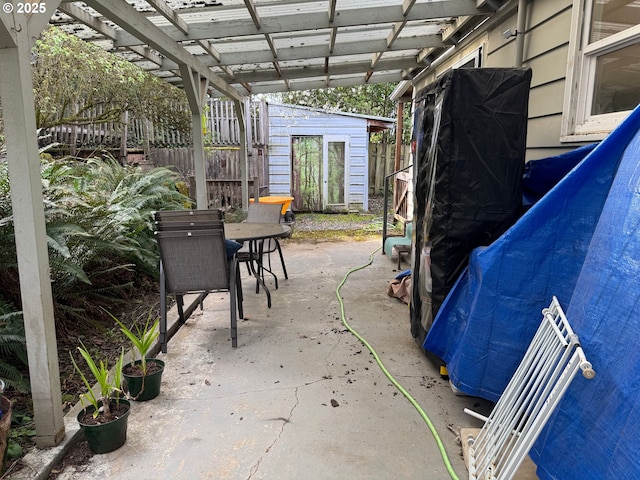 7922 SW Capitol Hill Rd, Portland, OR 97219 - view of patio / terrace with fence, a pergola, outdoor dining space, and an outdoor structure