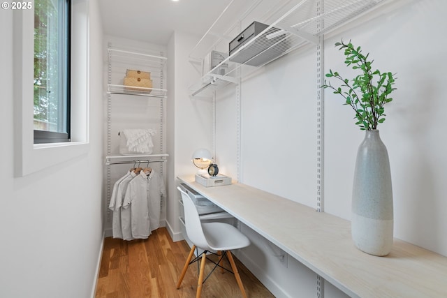 walk in closet featuring wood finished floors