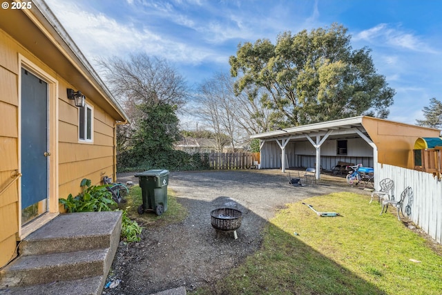 view of yard with an outdoor fire pit