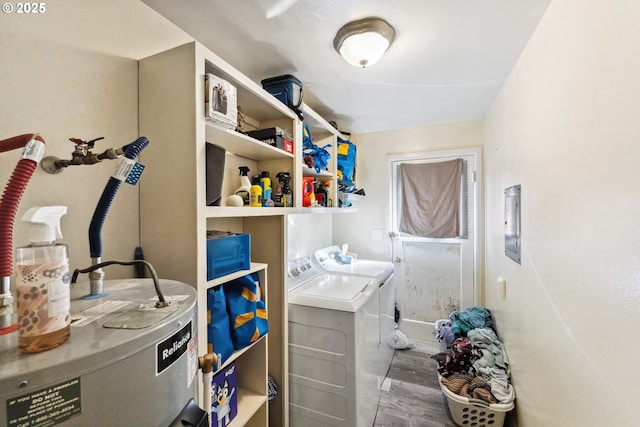 washroom featuring water heater, wood-type flooring, and washer and clothes dryer