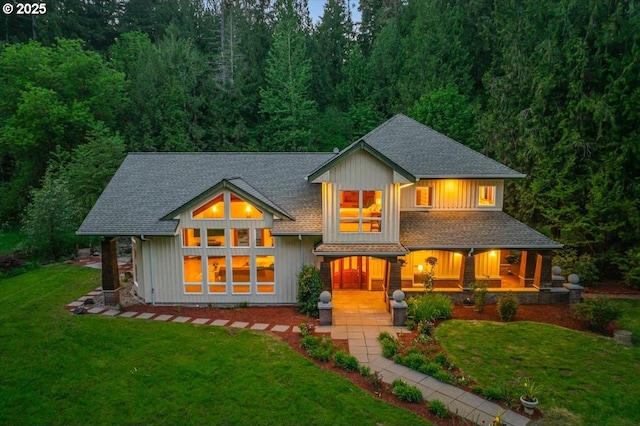 16316 NE 167th St, Brush Prairie, WA 98606 - back of house with a yard, covered porch, a shingled roof, and board and batten siding