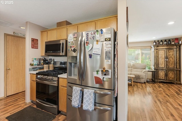 3977 SE Salquist Rd, Gresham, OR 97080 - kitchen featuring appliances with stainless steel finishes, light wood-type flooring, light countertops, recessed lighting, and light brown cabinetry