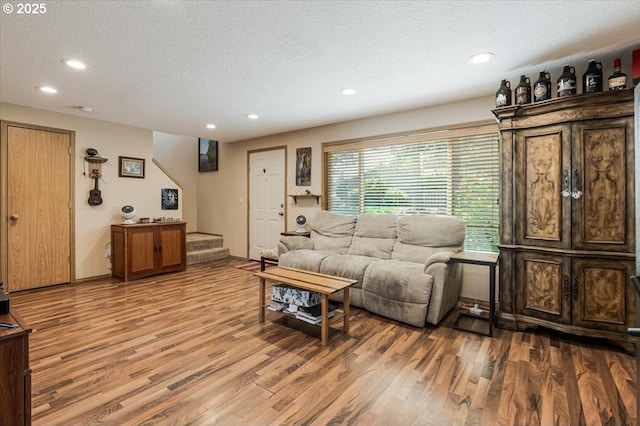 3977 SE Salquist Rd, Gresham, OR 97080 - living area featuring a textured ceiling, wood finished floors, stairs, and recessed lighting