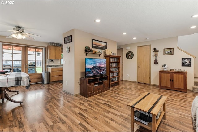 3977 SE Salquist Rd, Gresham, OR 97080 - living room with french doors, a ceiling fan, light wood-type flooring, recessed lighting, and a textured ceiling