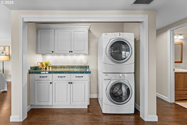 10620 SW Highland Dr, Portland, OR 97224 - laundry room featuring stacked washer / dryer and dark wood-type flooring