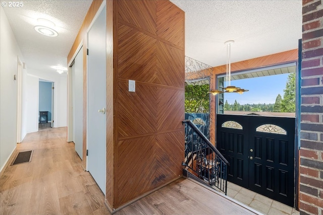 12208 SE 38th Ave, Milwaukie, OR 97222 - hall with wood finished floors, a textured ceiling, and an upstairs landing