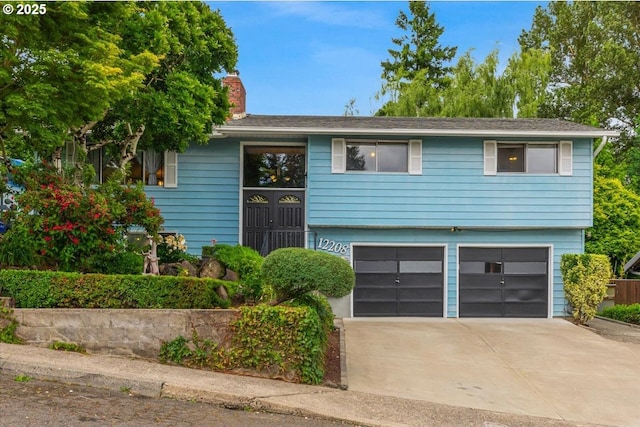 12208 SE 38th Ave, Milwaukie, OR 97222 - raised ranch featuring a garage, a chimney, and concrete driveway