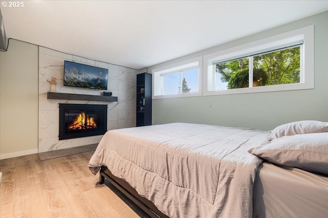 12208 SE 38th Ave, Milwaukie, OR 97222 - bedroom featuring wood finished floors, a tile fireplace, and baseboards