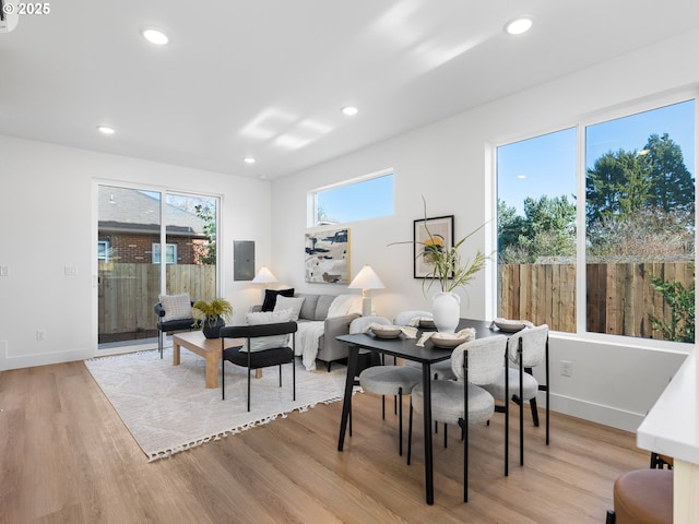 living room with electric panel and light hardwood / wood-style flooring