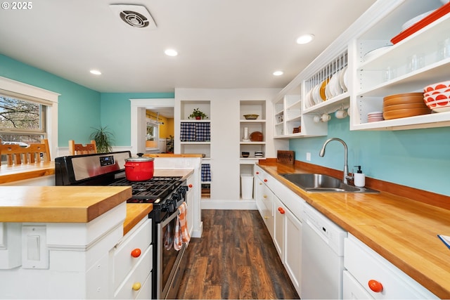 kitchen with visible vents, wooden counters, stainless steel range with gas stovetop, white dishwasher, and a sink