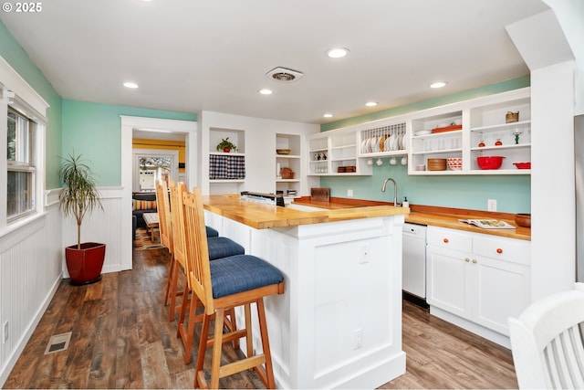 kitchen with visible vents, wooden counters, open shelves, a wainscoted wall, and dark wood-style flooring