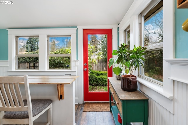 doorway with a healthy amount of sunlight and dark wood-style flooring