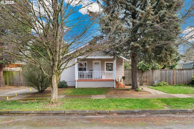 view of front of property with a porch and fence