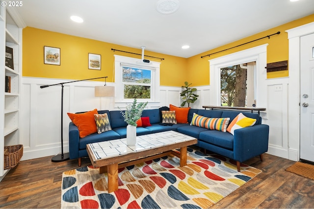 living room with wainscoting, a healthy amount of sunlight, and wood finished floors