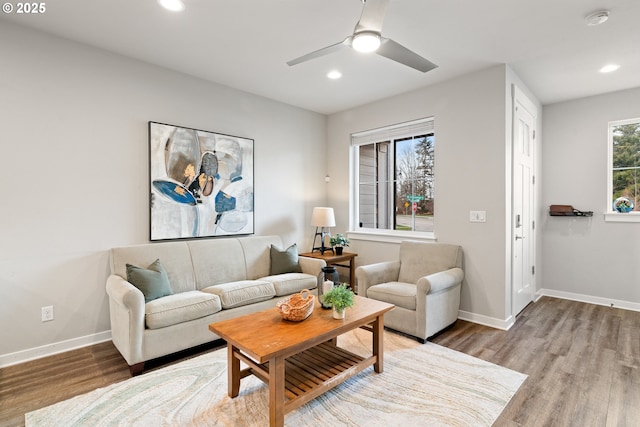 living room featuring a ceiling fan, recessed lighting, baseboards, and wood finished floors