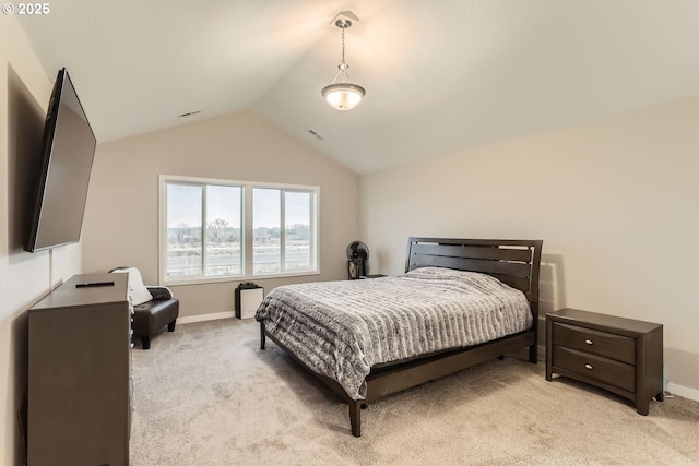 carpeted bedroom with lofted ceiling