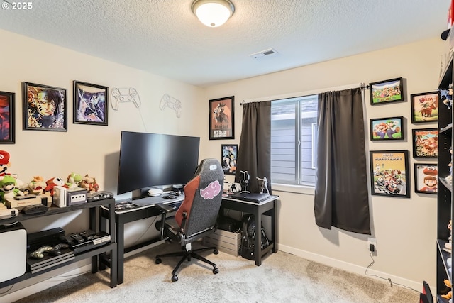 carpeted office space with a textured ceiling